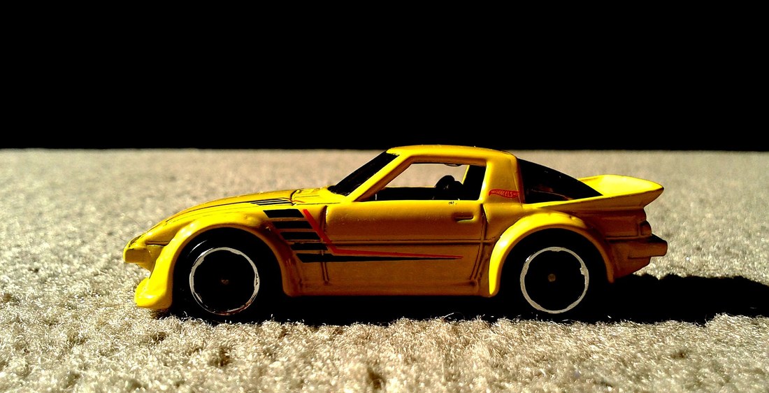 A yellow Hot Wheels Mazda RX-7 casting