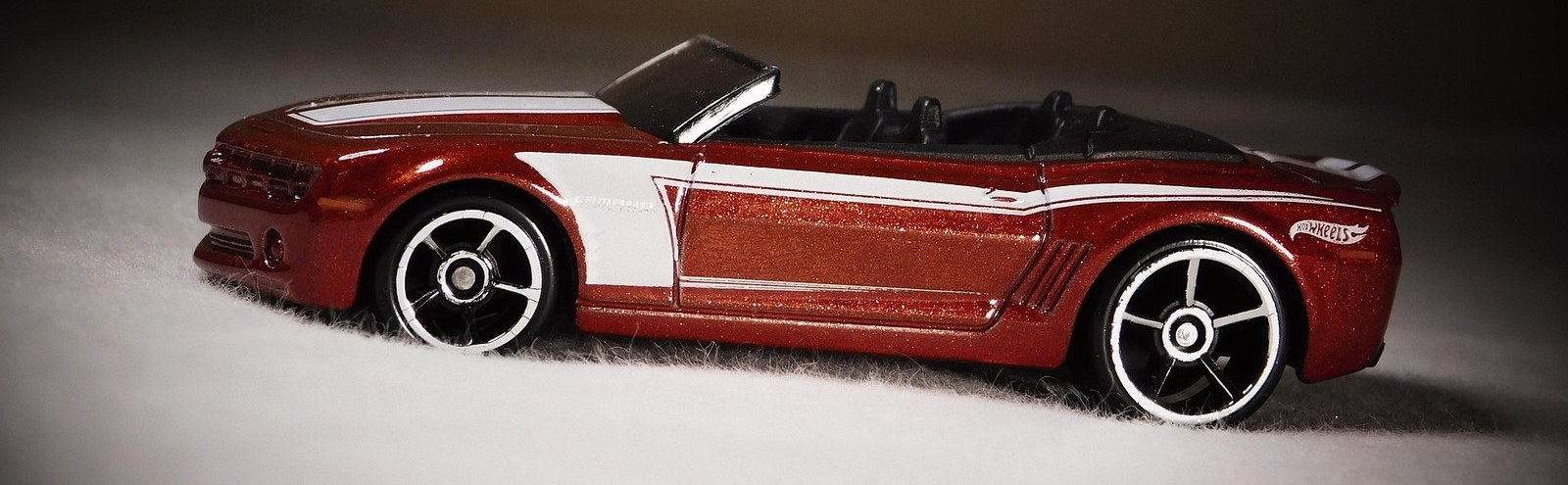 A red Hot Wheels Camaro convertible